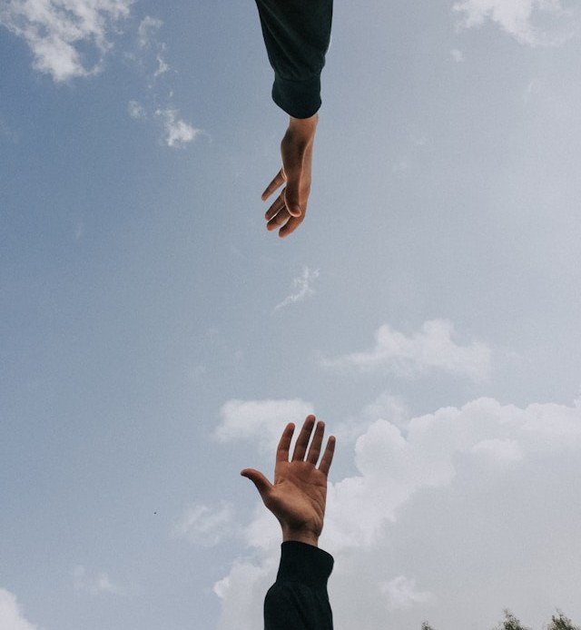 image of two hands reaching out to touch
